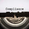 Compliance text text typed on an old vintage typewriter