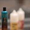 Extreme macro photography of electric cigarette with e-liquid in background