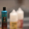 Extreme macro photography of electric cigarette with e-liquid in background