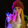 young woman blowing vape through her nose